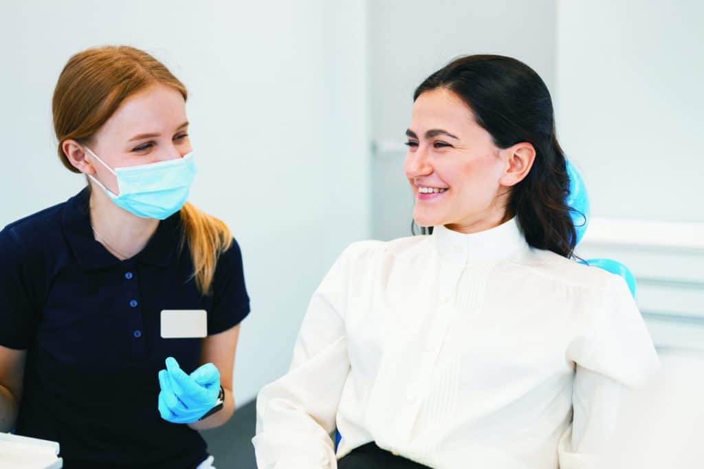 Dentist and female patient friendly talking