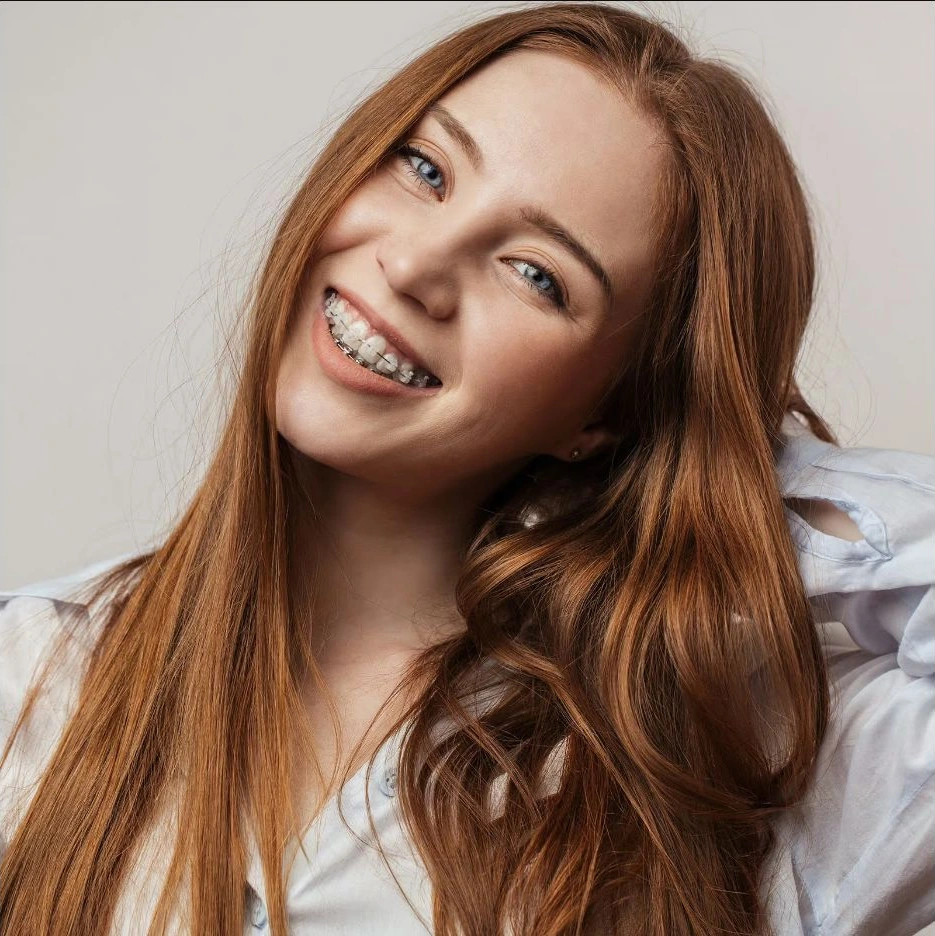 A smiling woman wearing braces